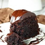 Slice of chocolate fudge bundt cake with chocolate ganache frosting.