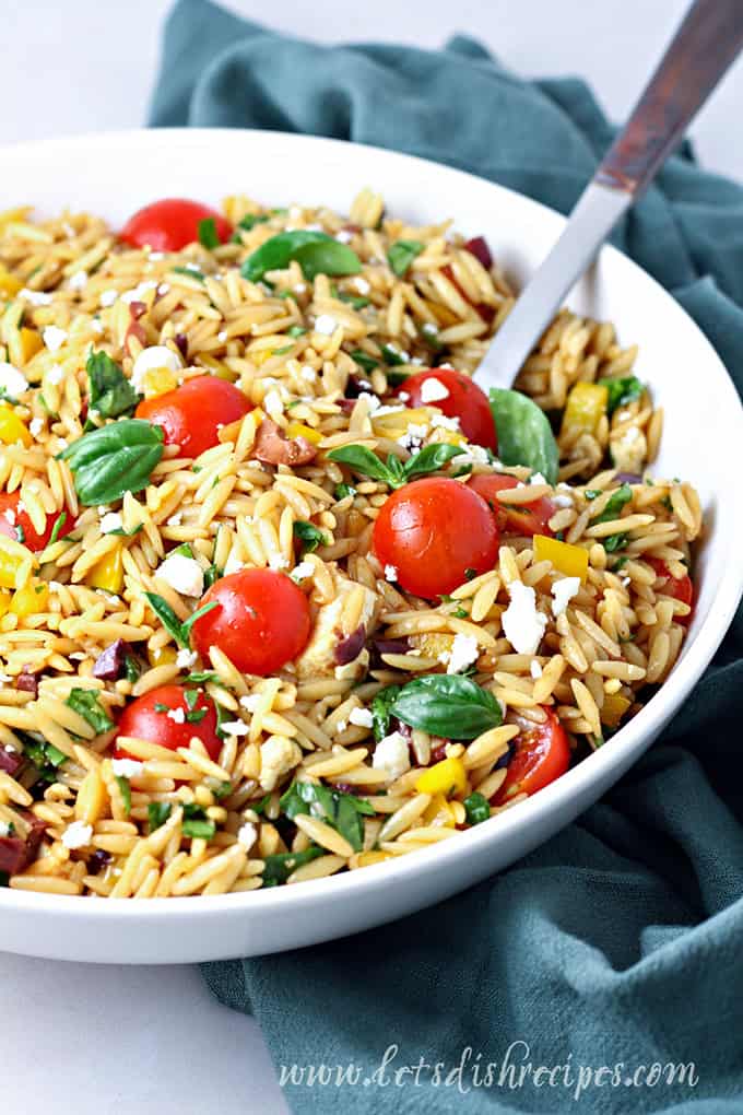 Mediterranean orzo salad with tomatoes, olives, feta and herbs.