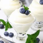 Lemon cheese cake mousse, piped into a dessert glass and topped with blueberries and mint.