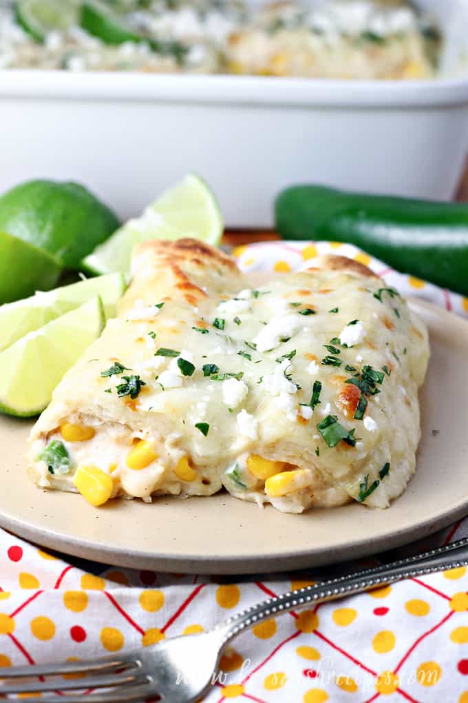 Plate of enchiladas filled with street corn and cheese.