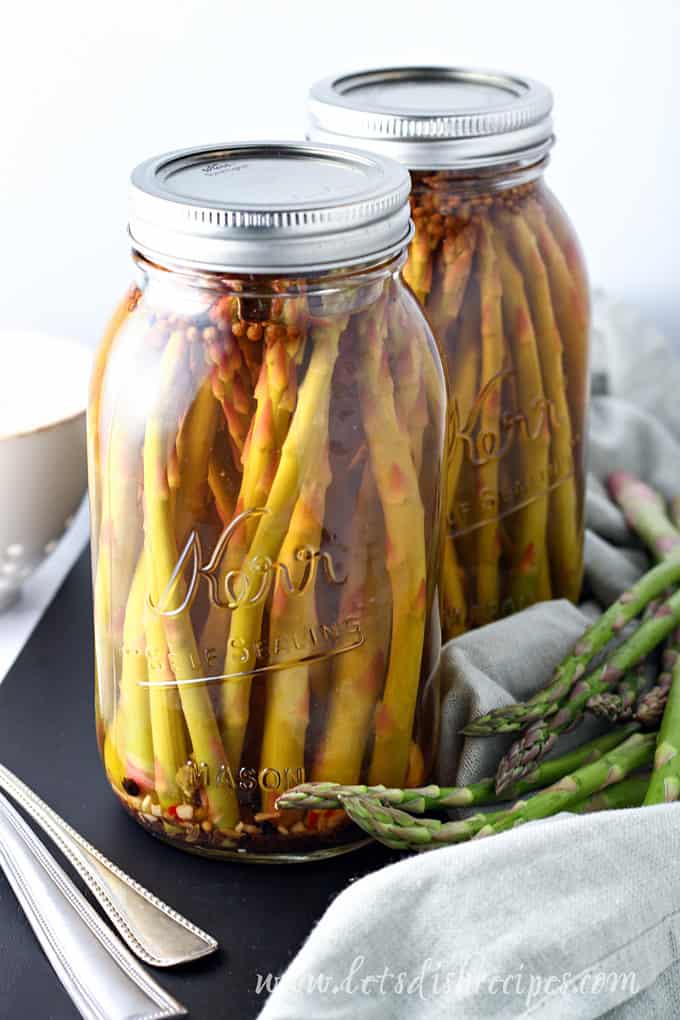 Pickled asparagus spears in a mason jar.