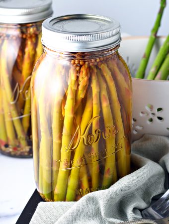 Pickled asparagus spears in a mason jar.