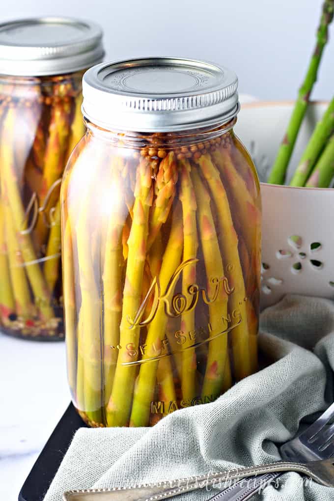 Pickled asparagus spears in a mason jar.